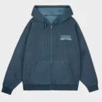 Front view of 1989 Taylor’s Version Is It Over Now blue zip-up hoodie with embroidered chest logo and full zip design